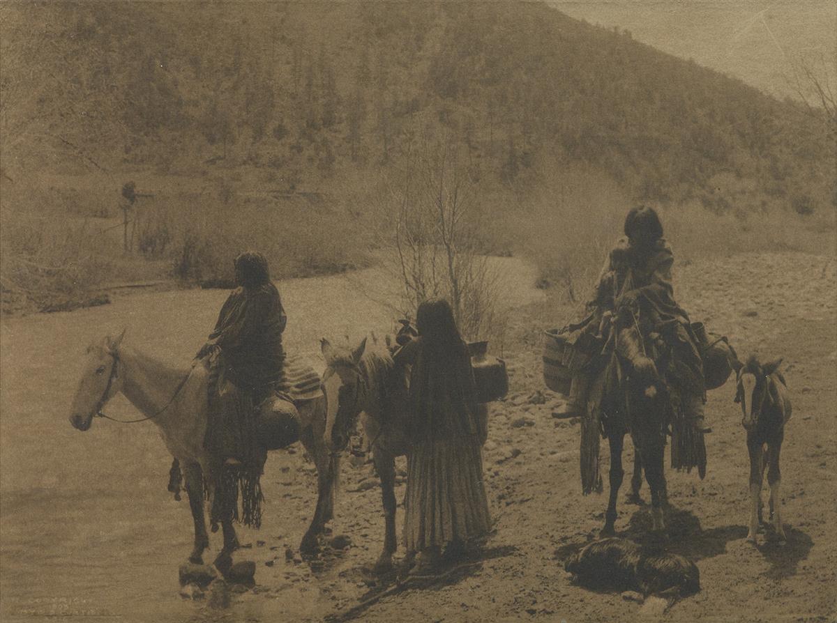 EDWARD S. CURTIS (1868-1952) Native American figures on horseback, with a dog and pony.
